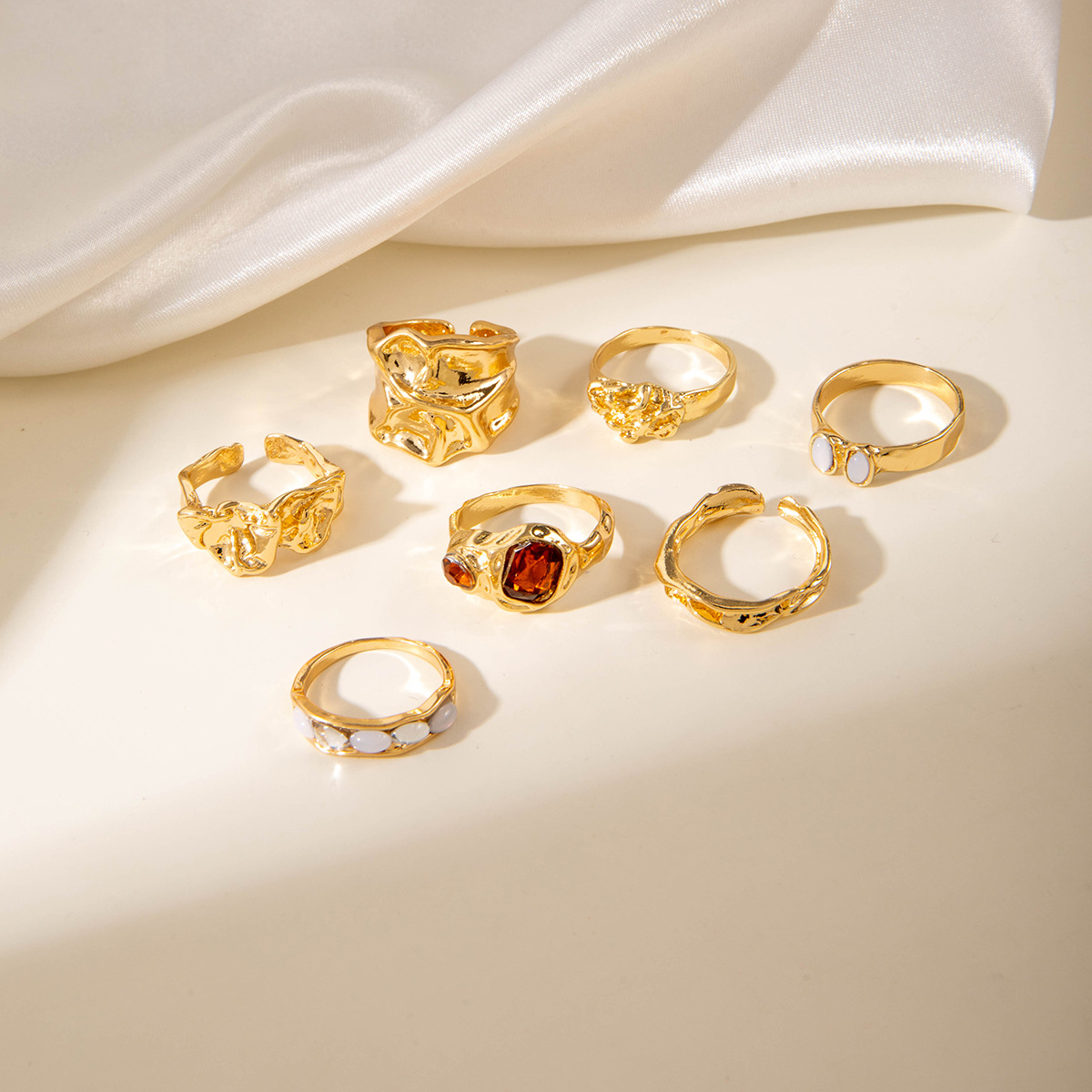 igh value jewelry styled on beach with linen and sunglasses